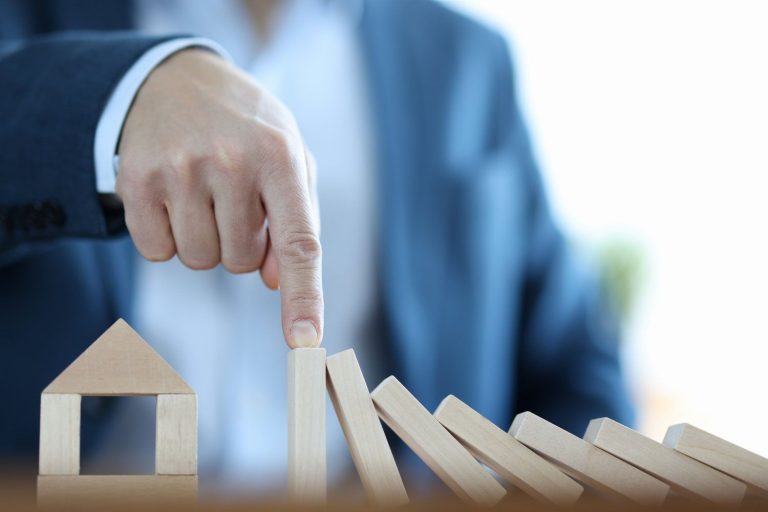 Businessman built house from wooden blocks